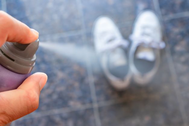 Disinfecting thrift store shoes using a disinfectant spray